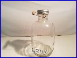 Antique One Gallon, glass jug with zinc lid and wooden handle w wire very old