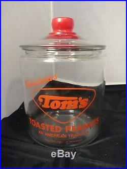 VINTAGE TOM'S TOASTED PEANUTS 5c GLASS JAR withGLASS LID RED EMBOSSED TOMs HANDLE